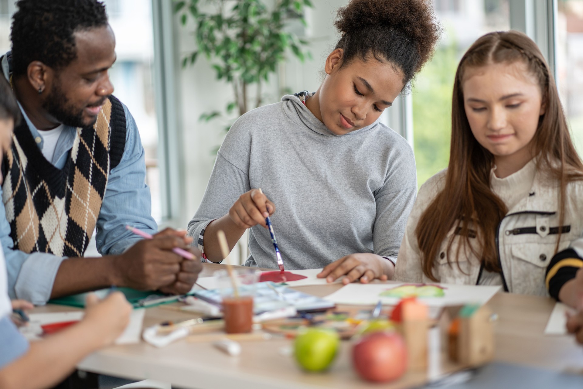 Diversity group of students drawing and painting in Arts class with African American teacher. kid enjoy practicing art skill, creative thinking idea. school activity, learning and education concept